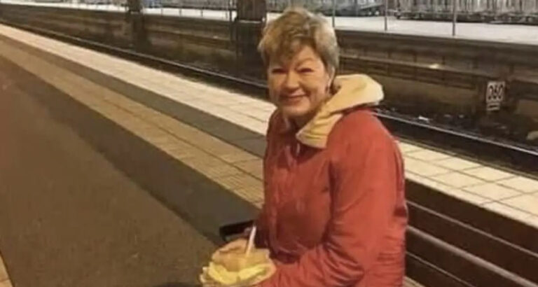 A woman is awaiting her train back to her house.